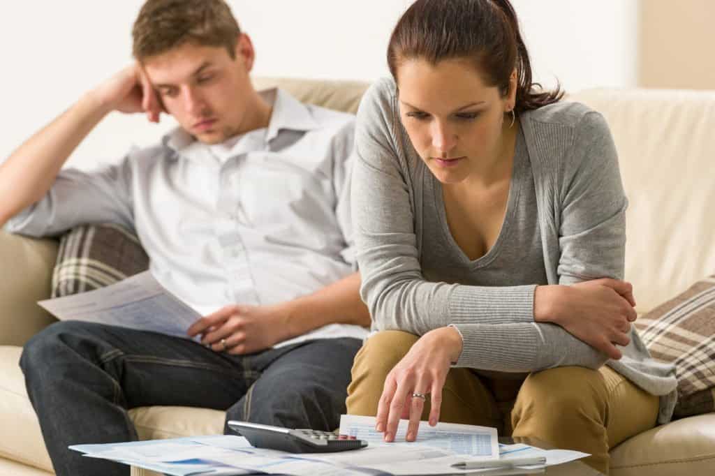 Stressed couple looking at their bills
