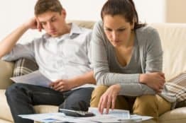 Stressed couple looking at their bills