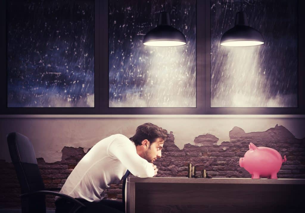 Man staring at piggy bank